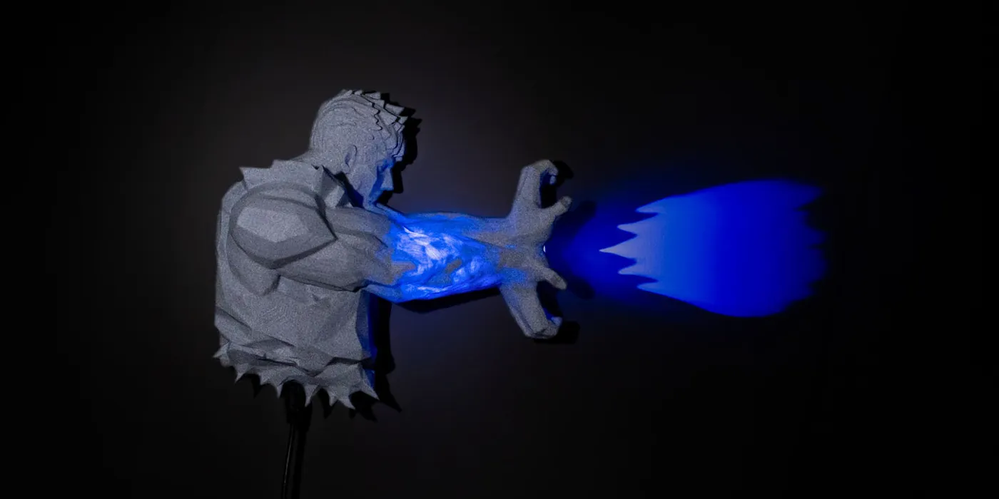 3D printed fighter wall light with blue energy blast glowing from his fist