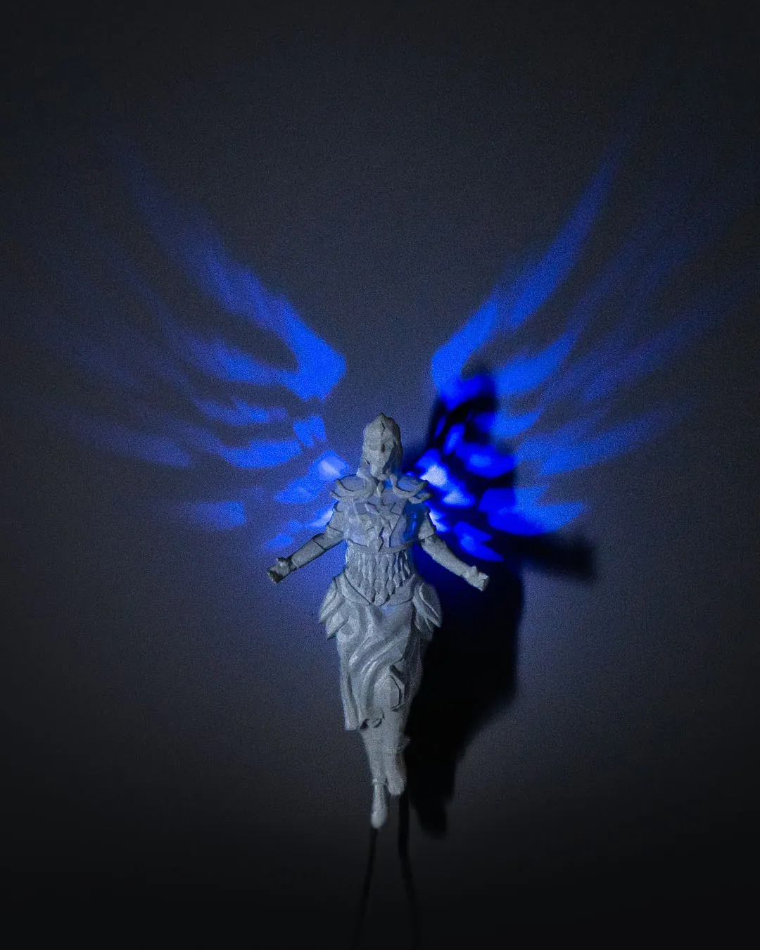 3D printed Valkyrie wall light with glowing blue wing shadows