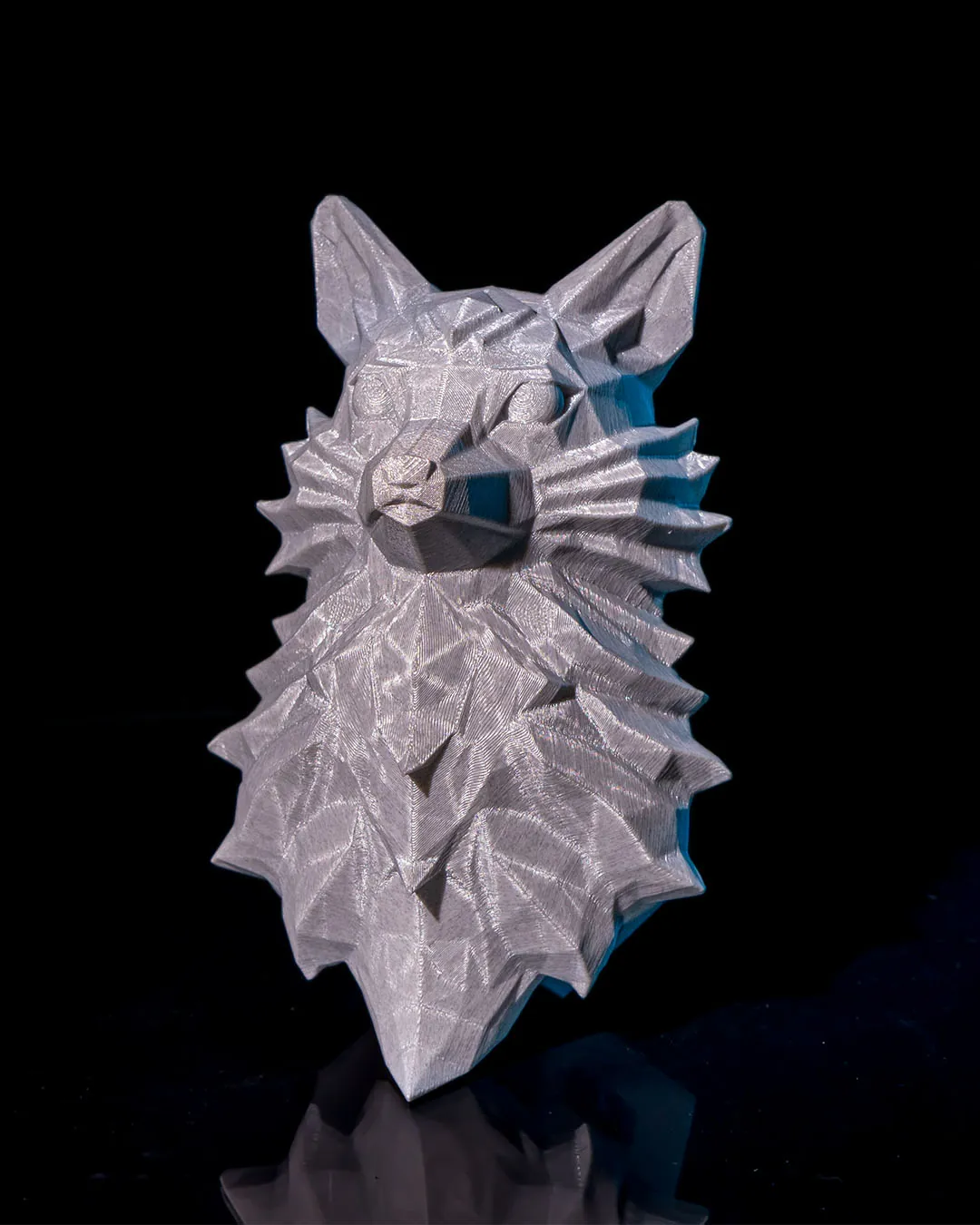 Low-poly 3D printed nine-tailed fox head on a black background