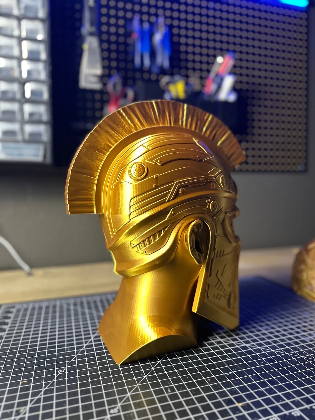 Gold 3D printed cyber Spartan headphone stand, three-quarter view