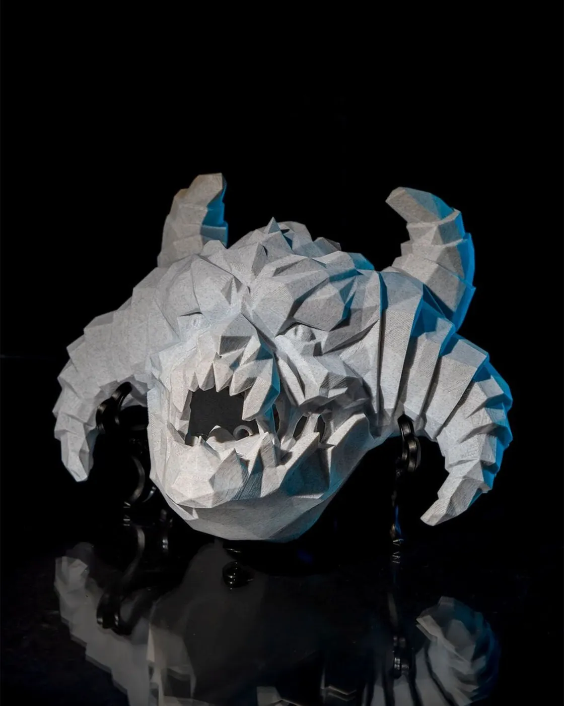 Low-poly 3D printed horned demon skull wall light, front view