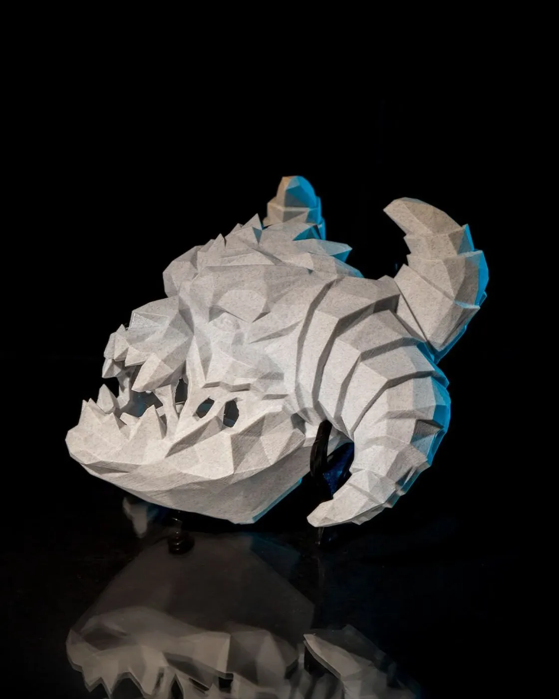 Low-poly 3D printed horned demon skull wall light, side view