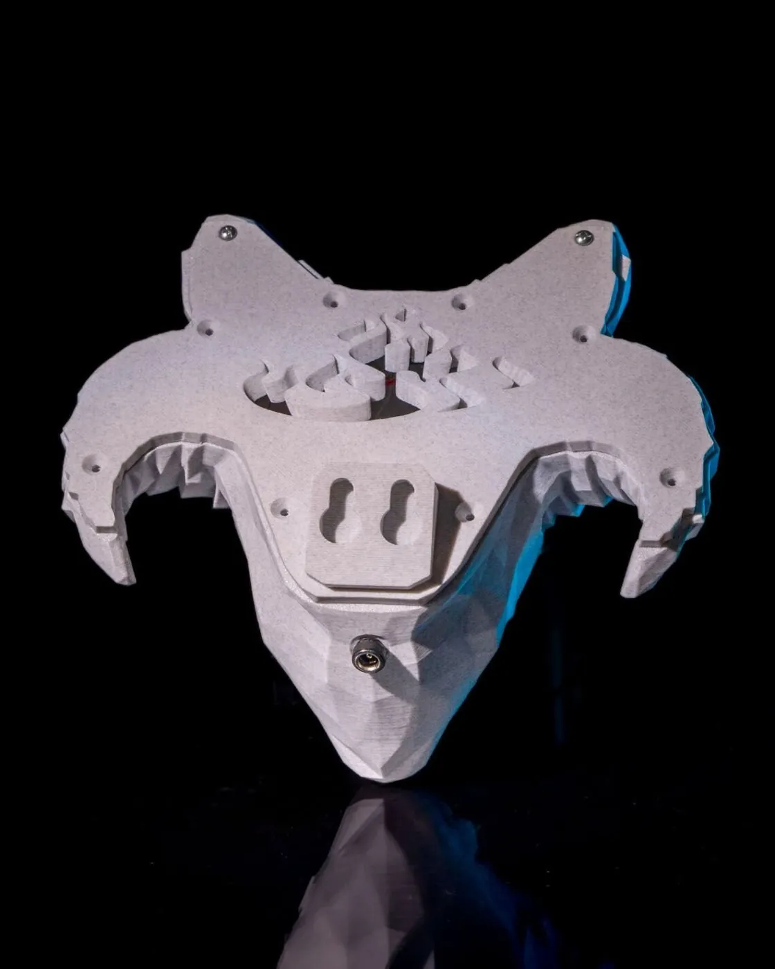 Back of a 3D printed demon wall light showing mounting holes and cable path