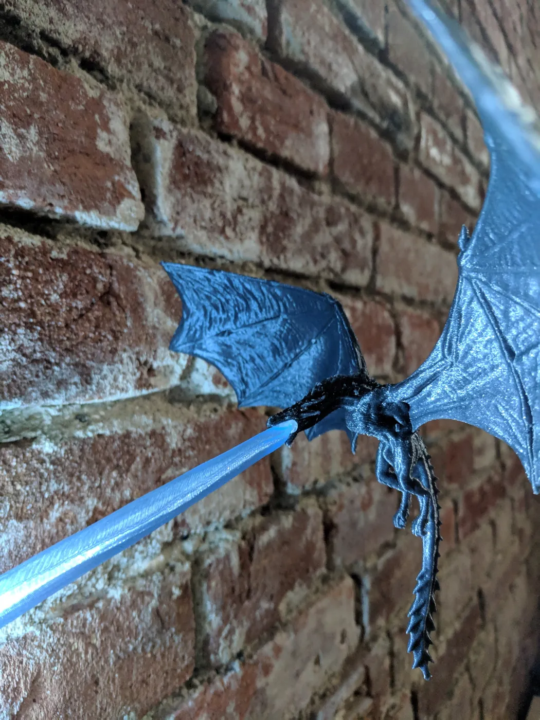 3D printed blue dragon wall lamp with a glowing blue fire beam
