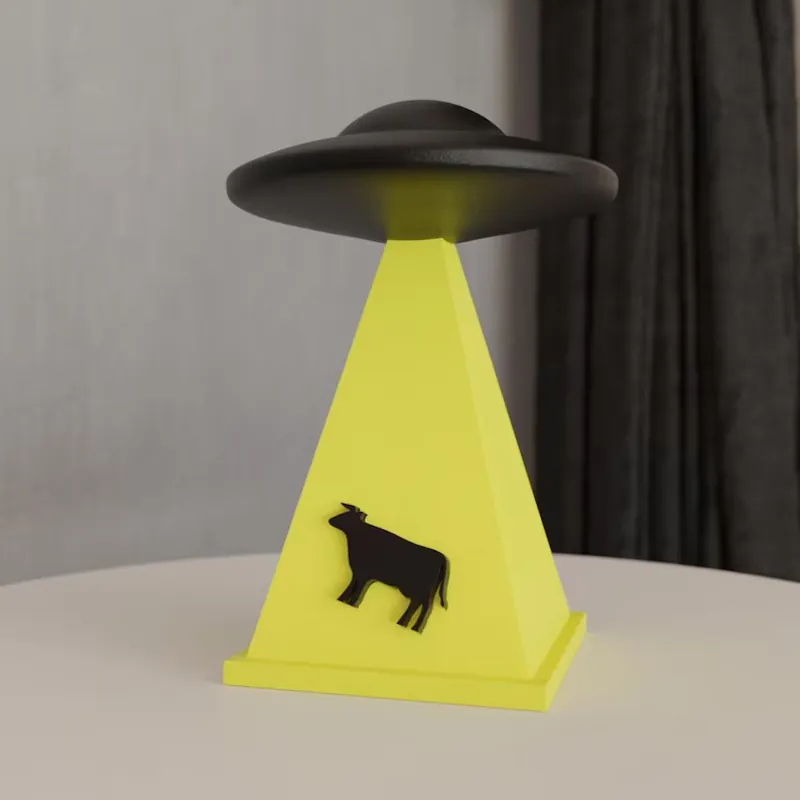 3D printed UFO lamp with yellow light beam and cow silhouette