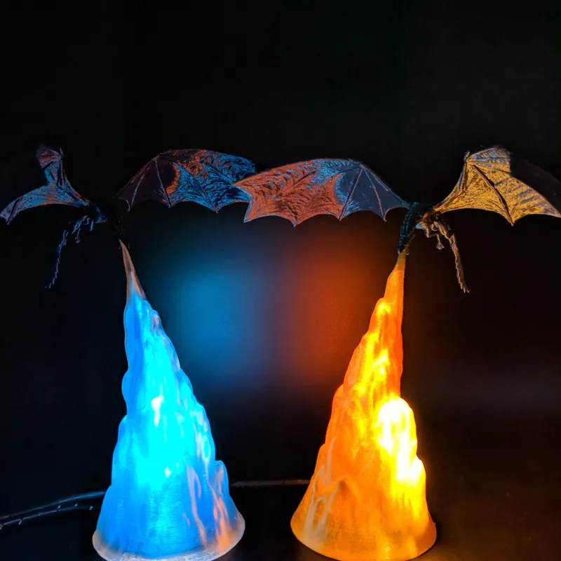 Pair of 3D printed dragon lamps glowing blue and orange