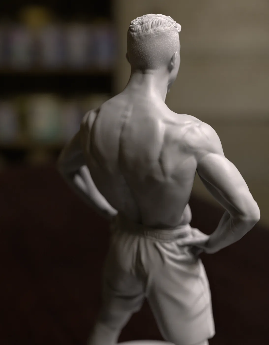 Back view of a 3D printed football player statue showing muscle detail