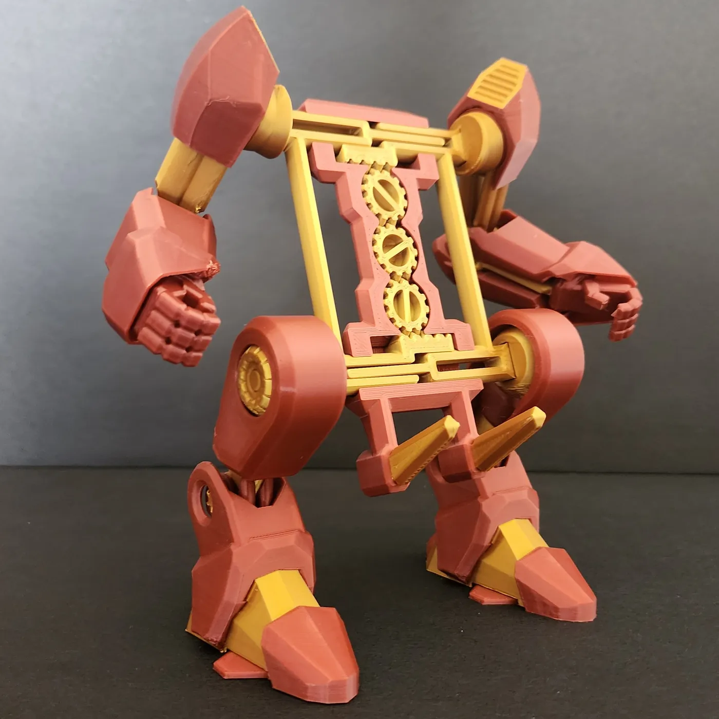 Red and gold articulated 3D printed robot exo-suit phone holder