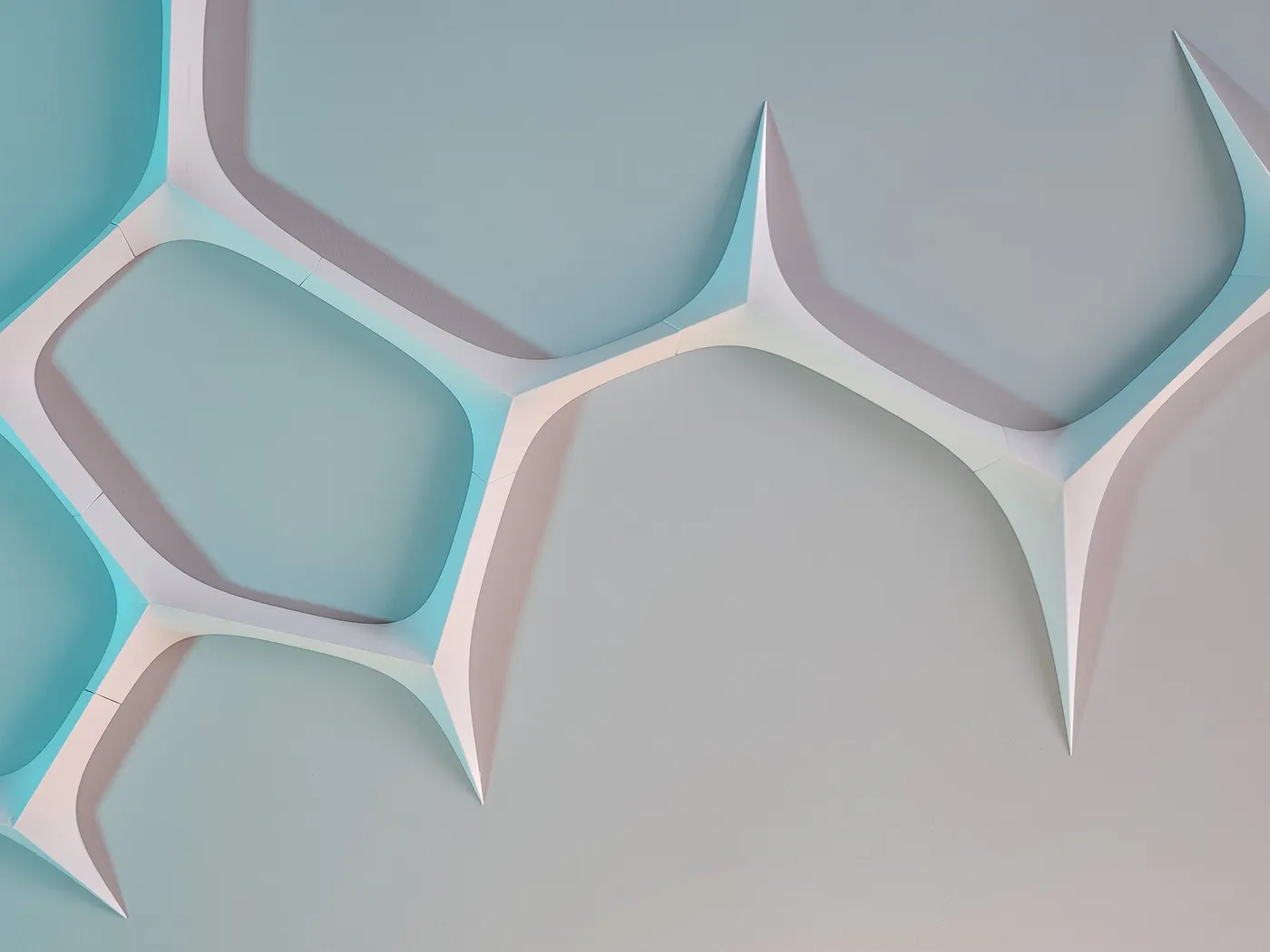 Close-up of white 3D printed neural network wall panels with teal backlight