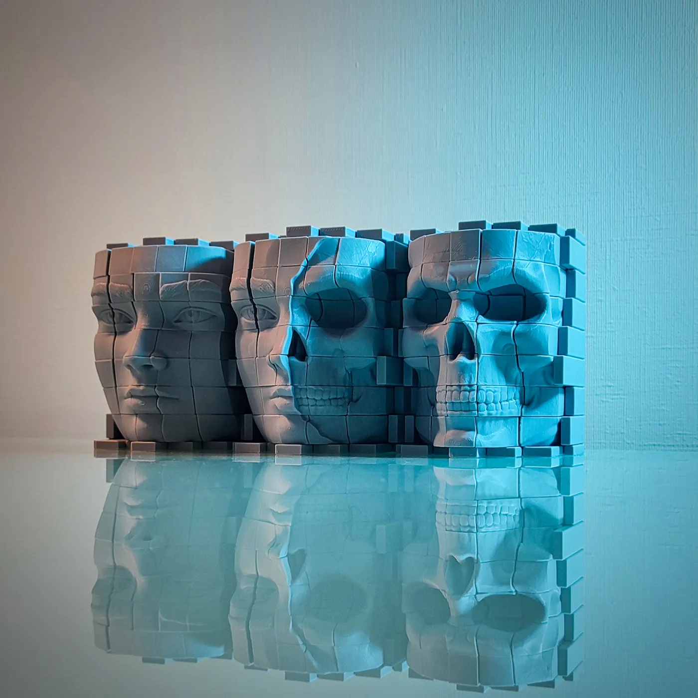 Row of 3D printed pixel heads morphing from female face to skull, reflected on glass